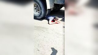 Gawkers Advises A Man Lying Under The Wheels Of A Truck To Go To T