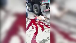 A Man's Broken Body Under The Wheels Of A Truck 