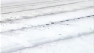 Woman Runs Through Snowy Street With Towel And Goes Underwater