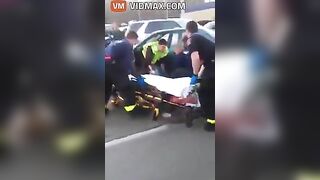 Nurse Performing CPR On Woman After Car Accident