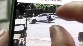 Young Couple crossing the Street together with Man in Front