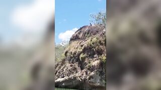 Young Man Jumping from Cliff in Honduras