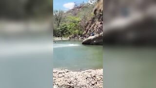 Young Man Jumping from Cliff in Honduras