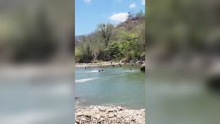 Young Man Jumping from Cliff in Honduras