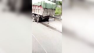 A Dead Old Man Pokes His Head Out From Under The Steering Wheel Of A Truck