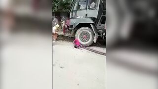 A Military Truck Drags A Woman Lying Under Its Wheels A(1)
