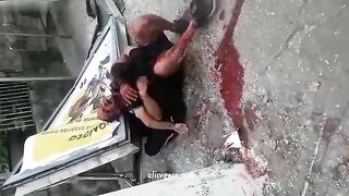 A Man Embraces The Body Of His Wife Who Was Killed In An Accident