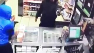 A Police Officer Enters A Store During A Robbery 