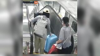Asian Woman Stupidly Leaves Luggage On Escalator Without Picking It Up
