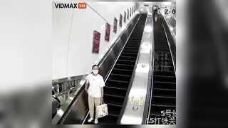 Asian Woman Stupidly Leaves Luggage On Escalator Without Picking It Up