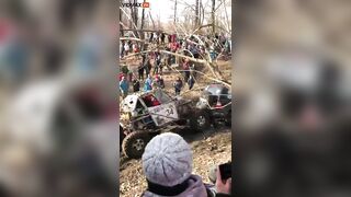 Guy Got Too Close To The Mud Race And Got Stuck Between Two Trucks