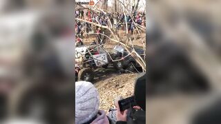 Guy Got Too Close To The Mud Race And Got Stuck Between Two Trucks