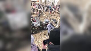 Guy Got Too Close To The Mud Race And Got Stuck Between Two Trucks