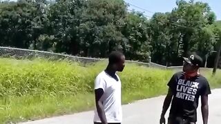 A Man Wearing A BLM T-shirt Grabs Another