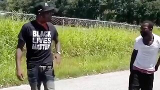 A Man Wearing A BLM T-shirt Grabs Another