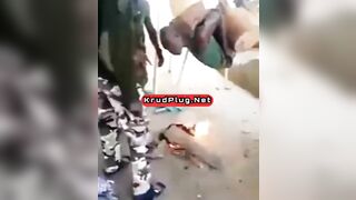 Man Tied To Device Standing Over Fire