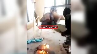 Man Tied To Device Standing Over Fire