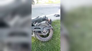 The Body Of A Motorcyclist Is Mixed With Helmet Fragments