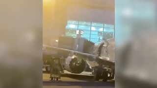 A Passenger Opens The Door And Jumps Onto The Wing At Miami-Dade Airport