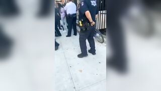 A Woman Puts Her Hand On NYPD Officer P During An Arrest