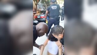 A Woman Puts Her Hand On NYPD Officer P During An Arrest