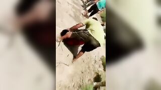 Group Of People Executed With Sticks And Kicks 