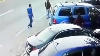 Man Trapped Between Reversing Car And Passing Truck 