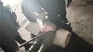 An RU Soldier Sticks A Stick Up A Prisoner's Butt To Analyze Him