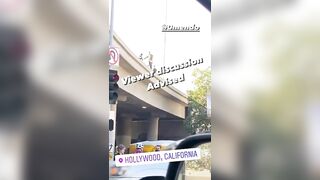 A Man Jumps Headfirst From A Bridge Into The Street 