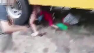 A Woman Shopping Falls Under The Wheels Of A Bus 