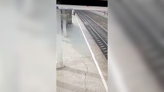 An Old Woman Lies On The Tracks In Front Of A Train 