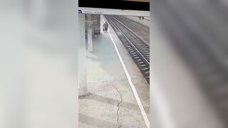 An Old Woman Lies On The Tracks In Front Of A Train 