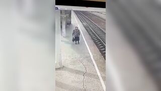 An Old Woman Lies On The Tracks In Front Of A Train 