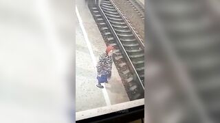 An Old Woman Lies On The Tracks In Front Of A Train 