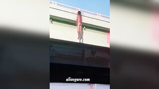 Dead Man Hanging On Bridge Railing 