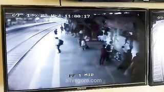 Guy Squatted On The Platform, Facing An Approaching Train