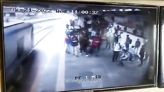 Guy Squatted On The Platform, Facing An Approaching Train