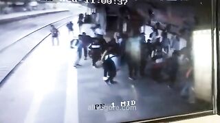 Guy Squatted On The Platform, Facing An Approaching Train