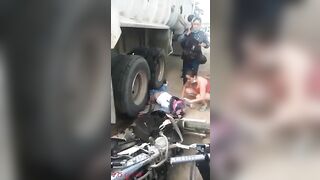 Motorcyclist's Legs Crushed By Truck Wheels 