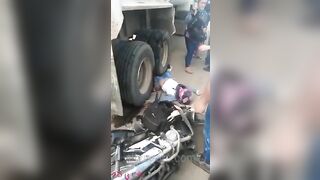 Motorcyclist's Legs Crushed By Truck Wheels 