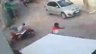 Pedestrian Hits Motorcyclist In The Head With Rock 