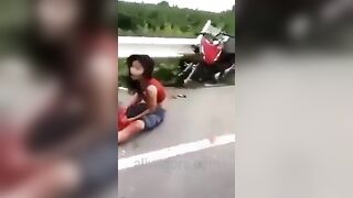 Woman's Legs Remain On Motorcycle 