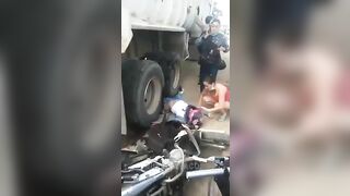 Motorcyclist Run Over By Truck Tire 