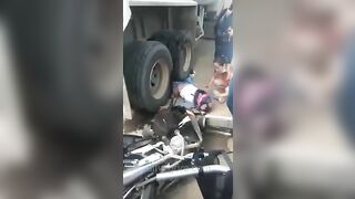 Motorcyclist Run Over By Truck Tire 