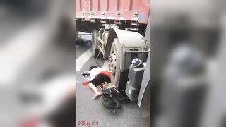 Woman Riding Scooter Under Truck Wheel 