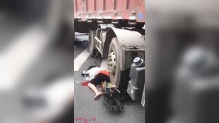 Woman Riding Scooter Under Truck Wheel 