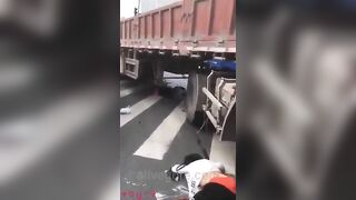 Woman Riding Scooter Under Truck Wheel 