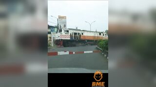 Cyclist Brakes While Crossing The Road In Front Of A Train
