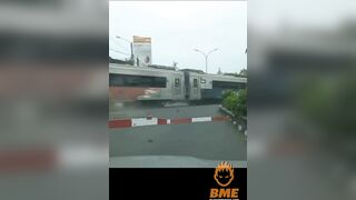 Cyclist Brakes While Crossing The Road In Front Of A Train