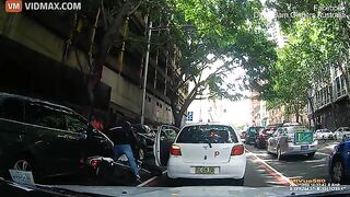 A Delivery Driver On A Scooter Crashed Straight Into An Open Car Door